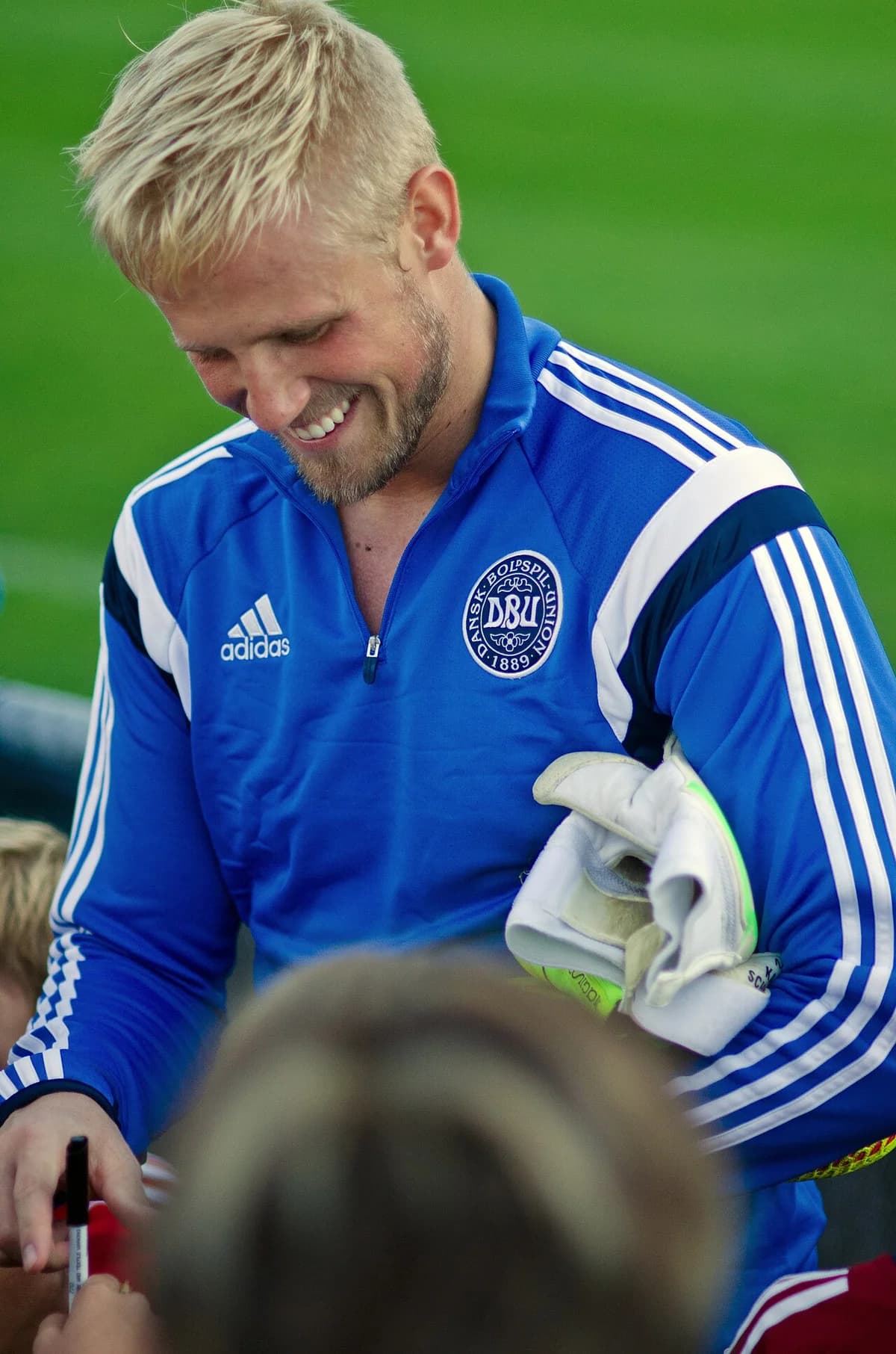 Kasper Schmeichel smiling during Denmark national team training.