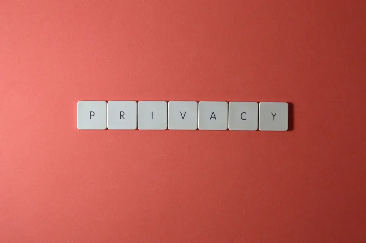 Letter tiles spelling privacy on a red background.