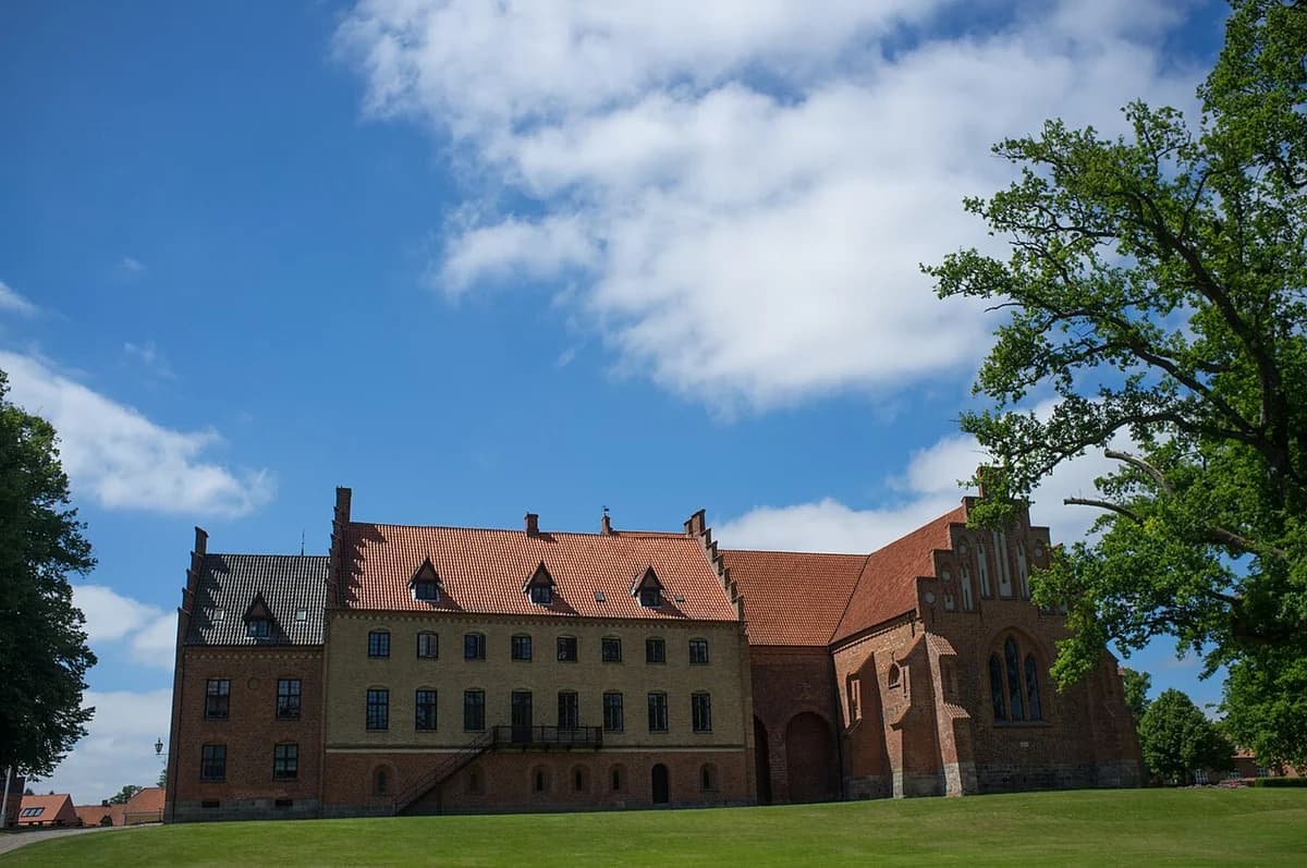 Historic monastery building of Herlufsholm Boarding School in Denmark under a blue sky
