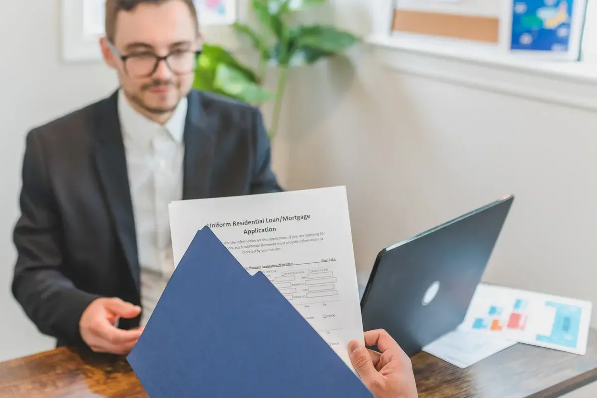 Mortgage broker and client discussing loan documents