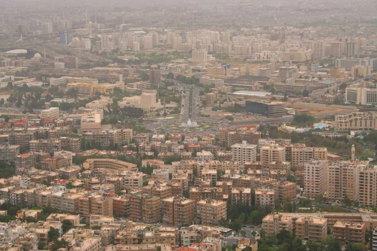 Panoramic view of Damascus skyline with dense city buildings.