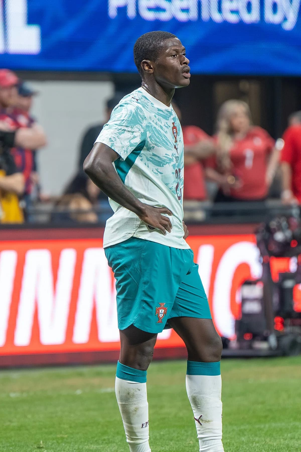 Nuno Mendes standing on the pitch during a Portugal match.