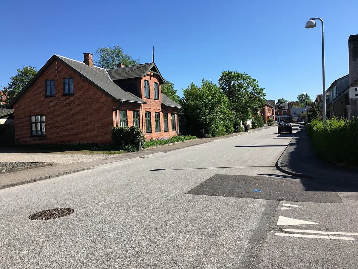 A red brick house on a quiet street in Haslev, Denmark.