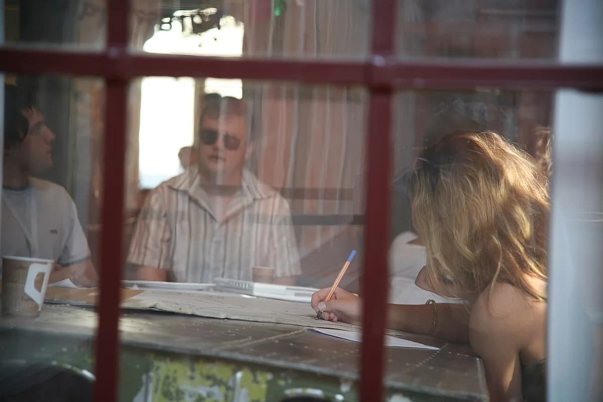 Students studying together indoors through window