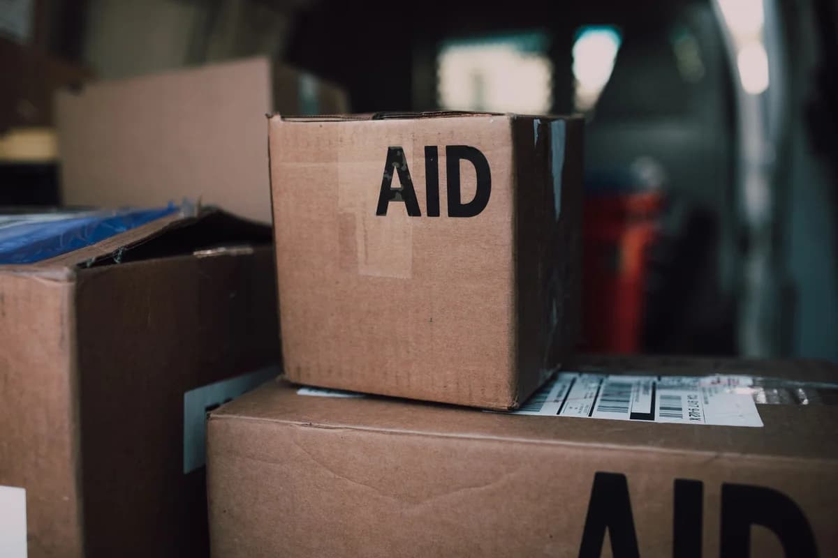 Stacked aid boxes labeled 'AID' inside a delivery vehicle