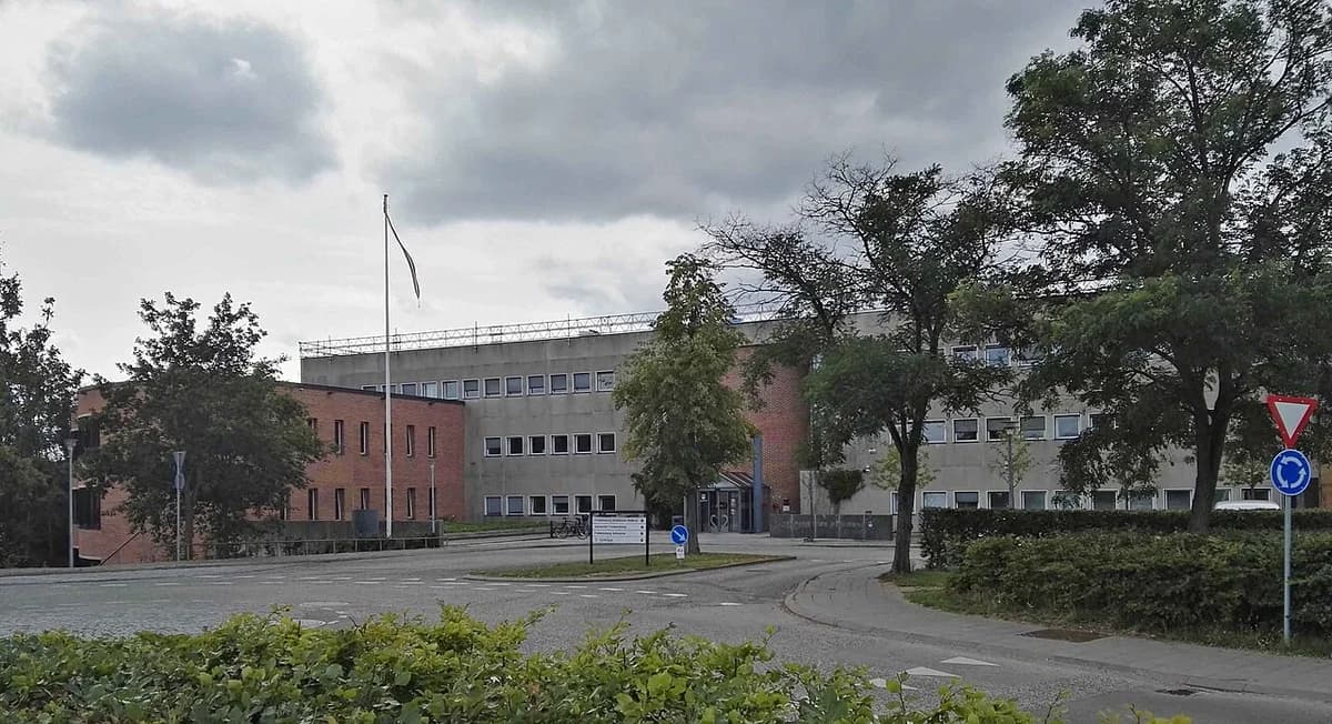 Exterior view of Kokkedal Town Hall building with trees and roundabout in front