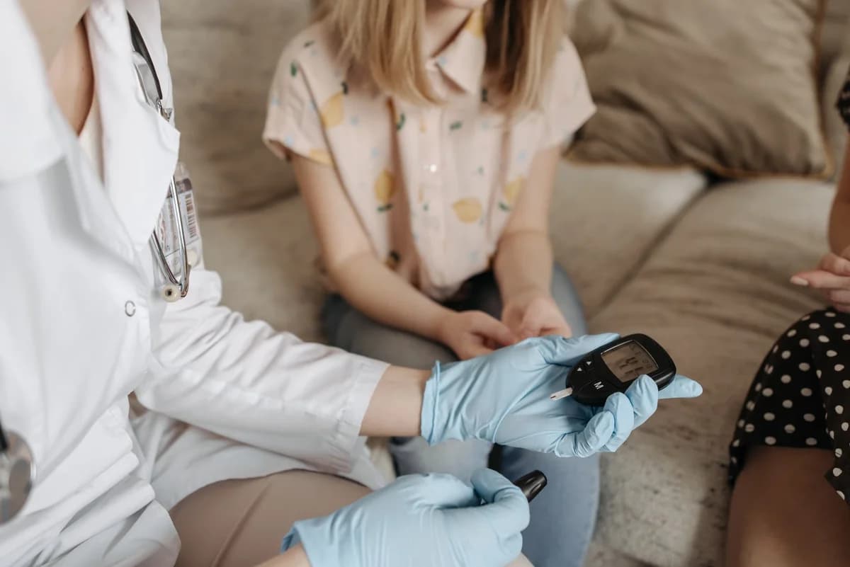 Doctor using a glucose meter to check a patient's blood sugar.