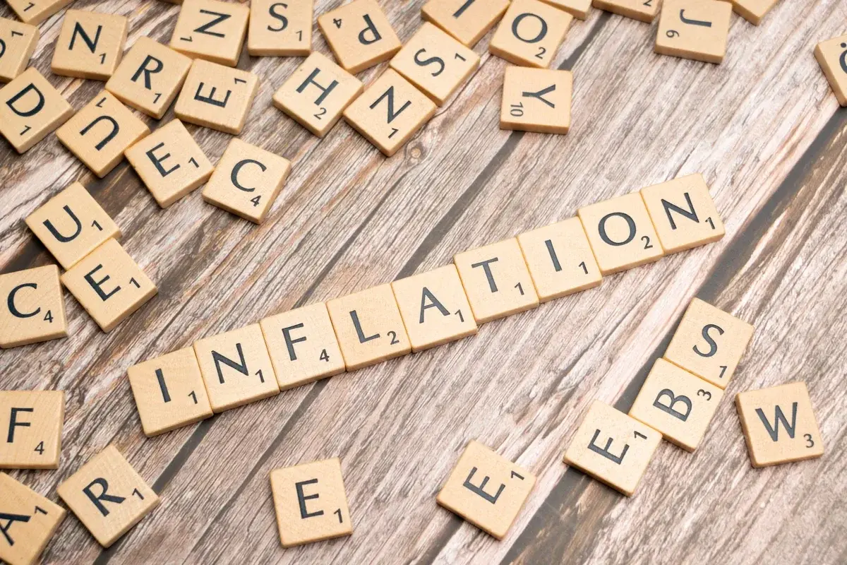 Wooden tiles spelling inflation on rustic wood