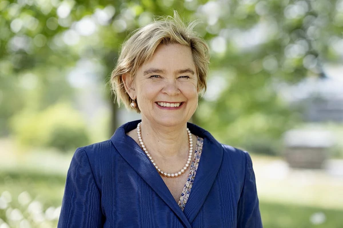 Portrait of Professor Lone Simonsen outdoors smiling in a blue jacket.