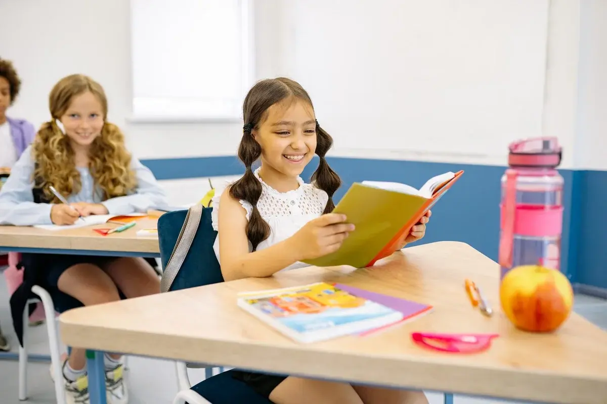 Children reading and writing in a bright classroom