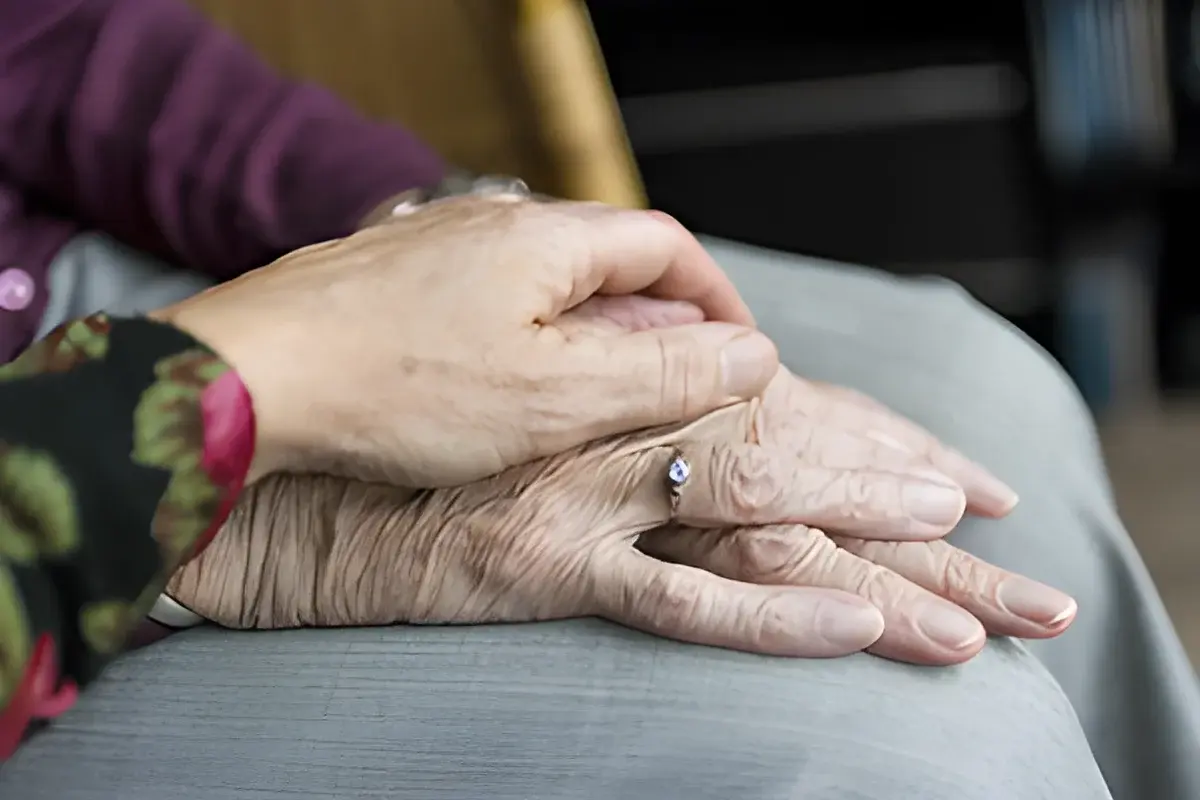 two hands, one holding the other