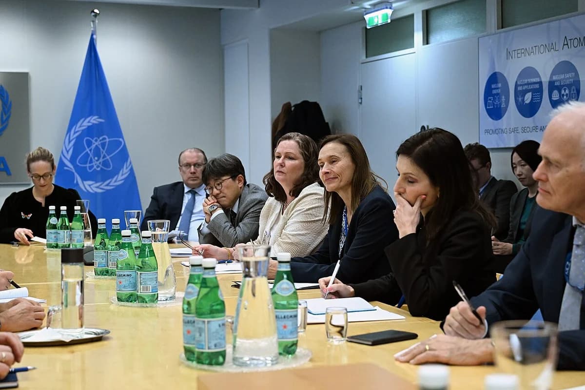 International representatives seated around a conference table during a formal meeting at the IAEA headquarters in Vienna.