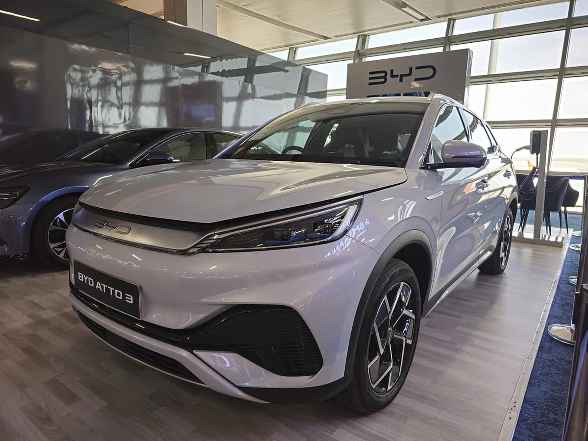 A BYD Atto 3 electric SUV on display indoors.