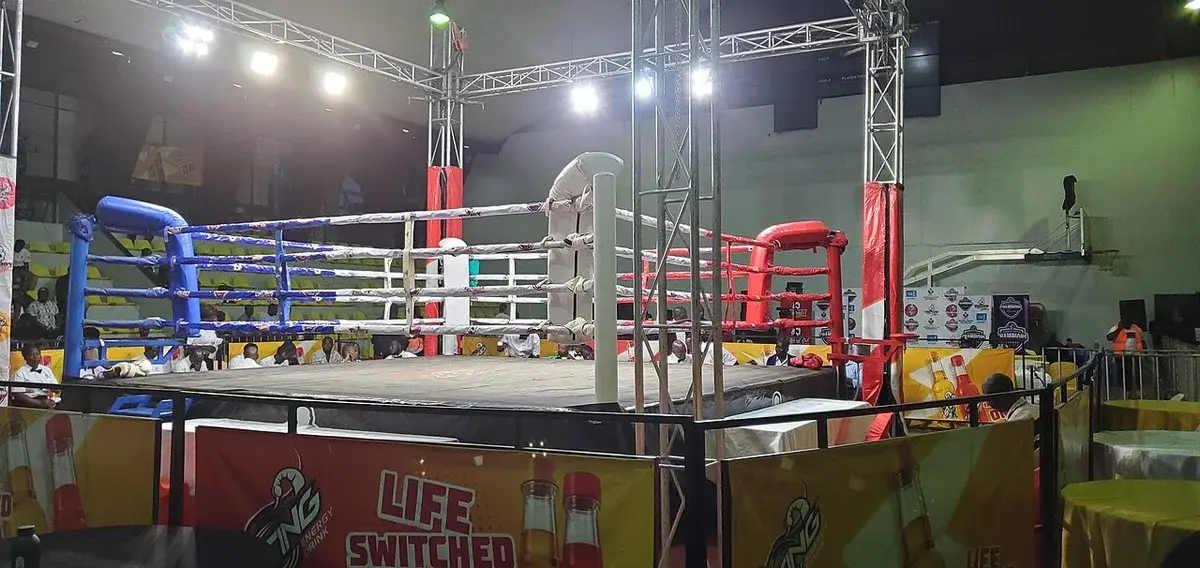 A boxing ring being set up inside an arena.