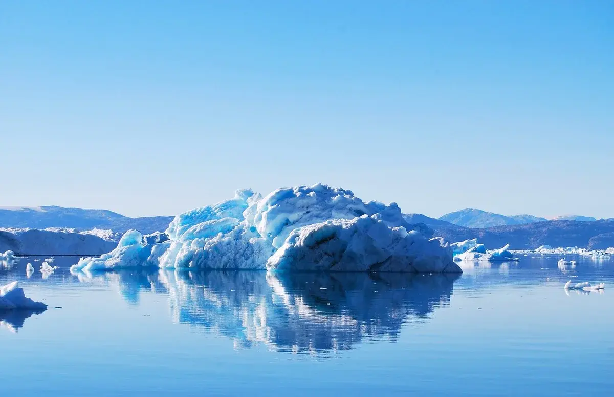 Icebergs floating in a calm Greenland fjord