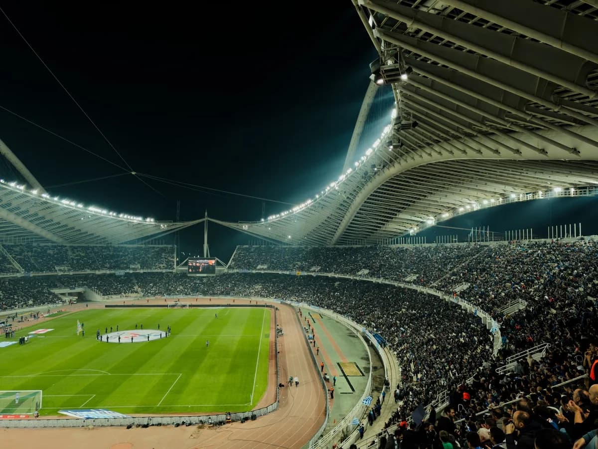 packed football stadium with bright lights at night