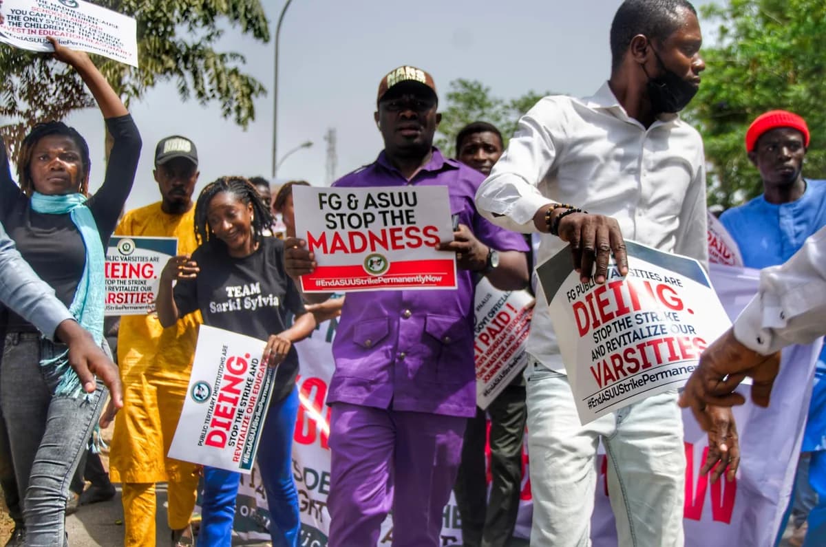 People protesting with signs against university strikes and education crisis