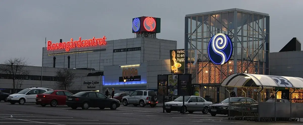 Exterior view of Rosengårdcentret shopping center in Odense during evening with parked cars