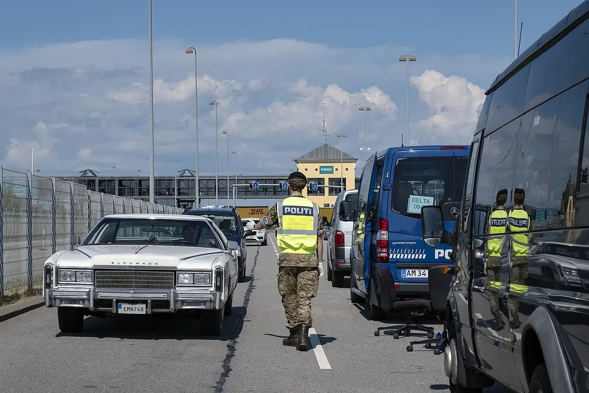 A Danish police officer checks vehicles at a ferry terminal border control point in Helsingør.