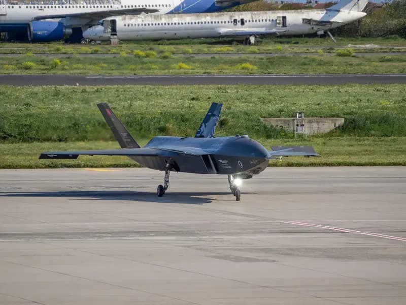 Black military drone on airport runway