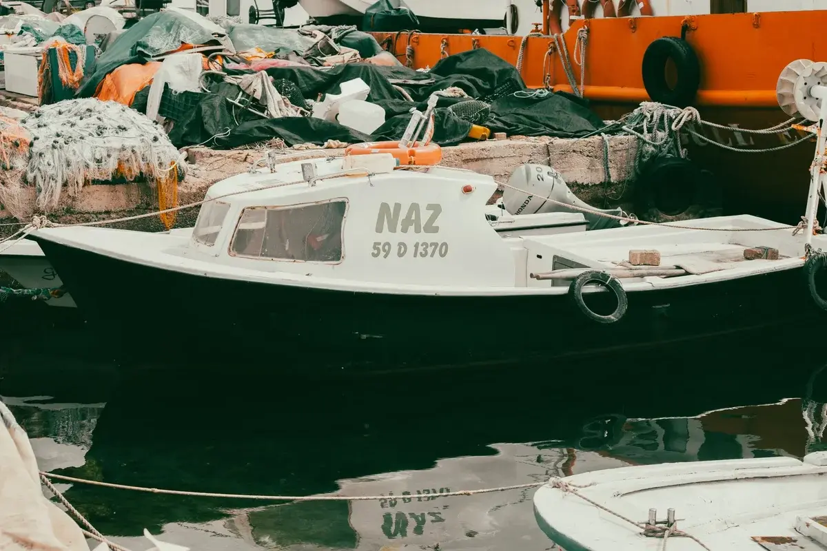 Fishing boat in harbor with nets and equipment