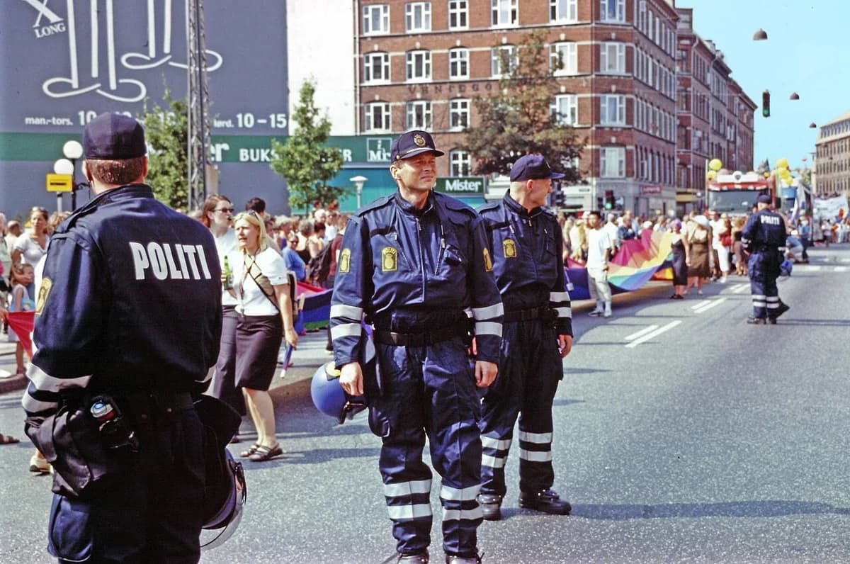 Police officers standing at a Pride parade in Copenhagen.
