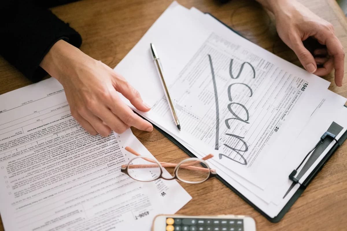 Tax forms on desk marked with the word scam