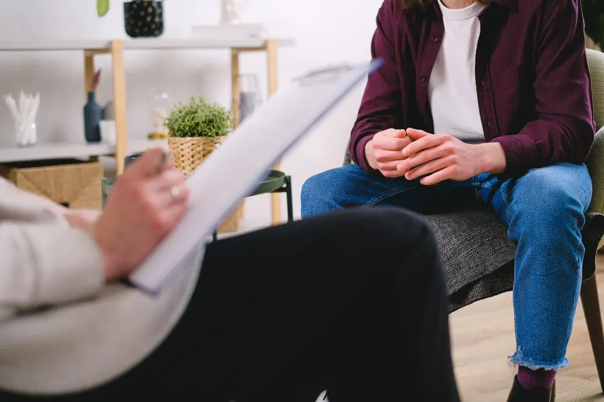 A therapist speaking with a client during a counseling session.
