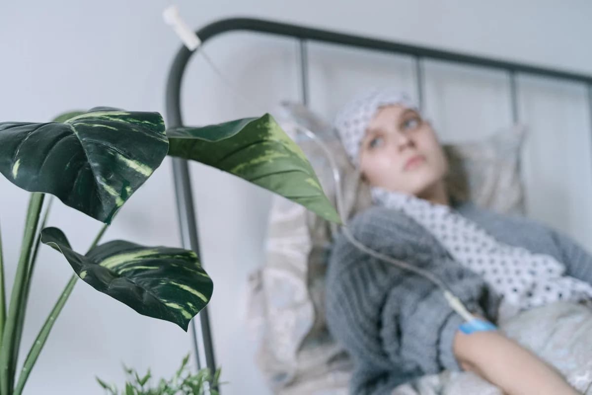 patient lying in hospital bed with IV drip