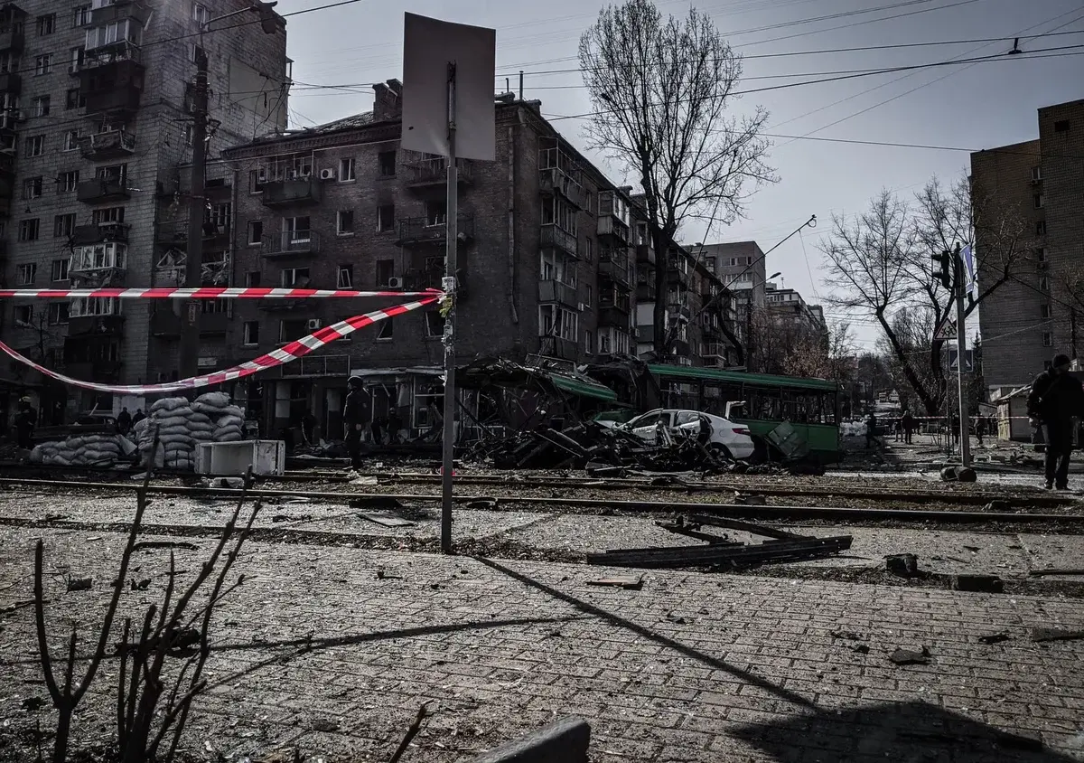 A war-damaged street in Kyiv with destroyed buildings and debris.
