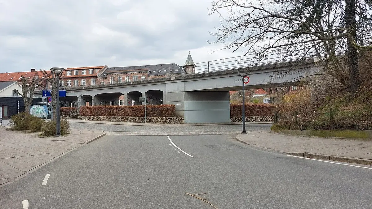 An elevated railway bridge over a street in Vejle, Denmark.