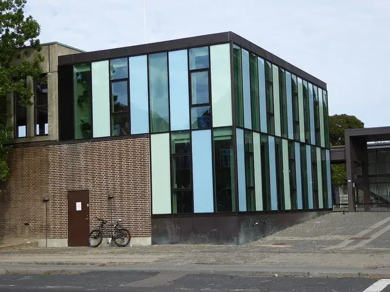 Modern building extension with glass panels and brickwork at Øregård Gymnasium