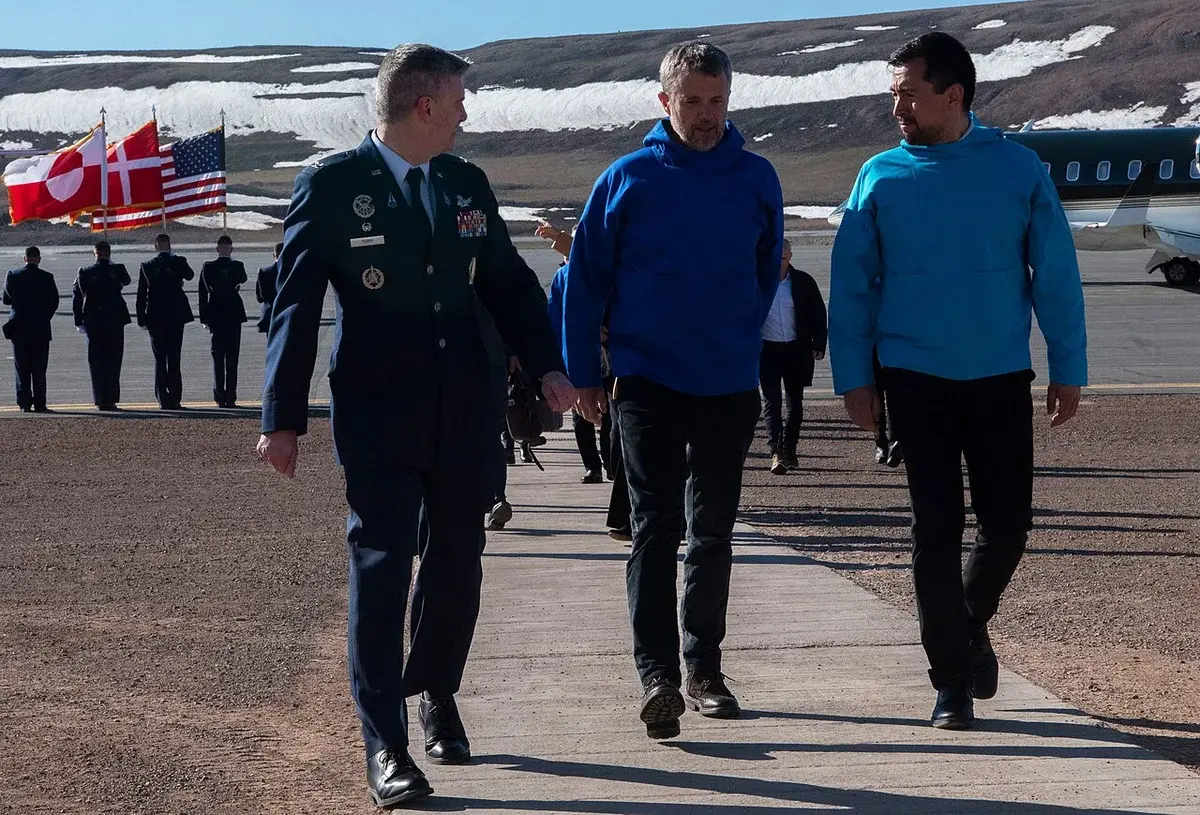 King Frederik X walks with U.S. Space Force Col. Jason Terry and Múte Bourup Egede at Pituffik Space Base.