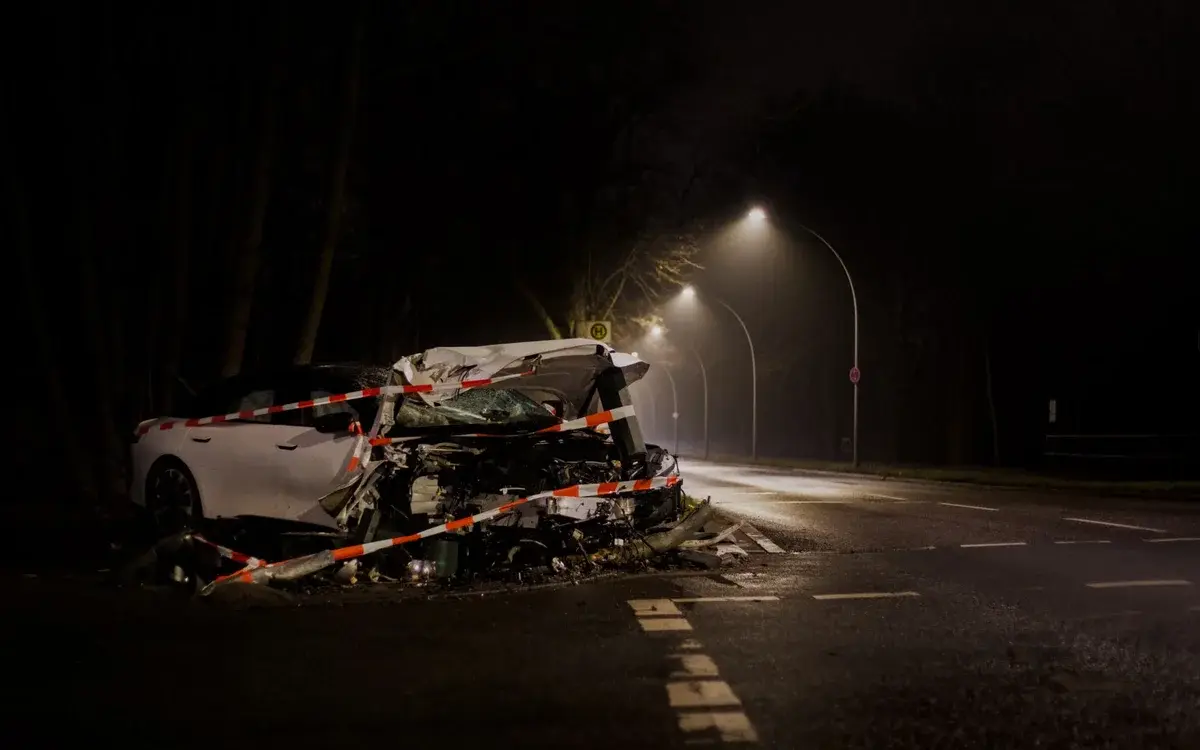Wrecked car on dark street at night