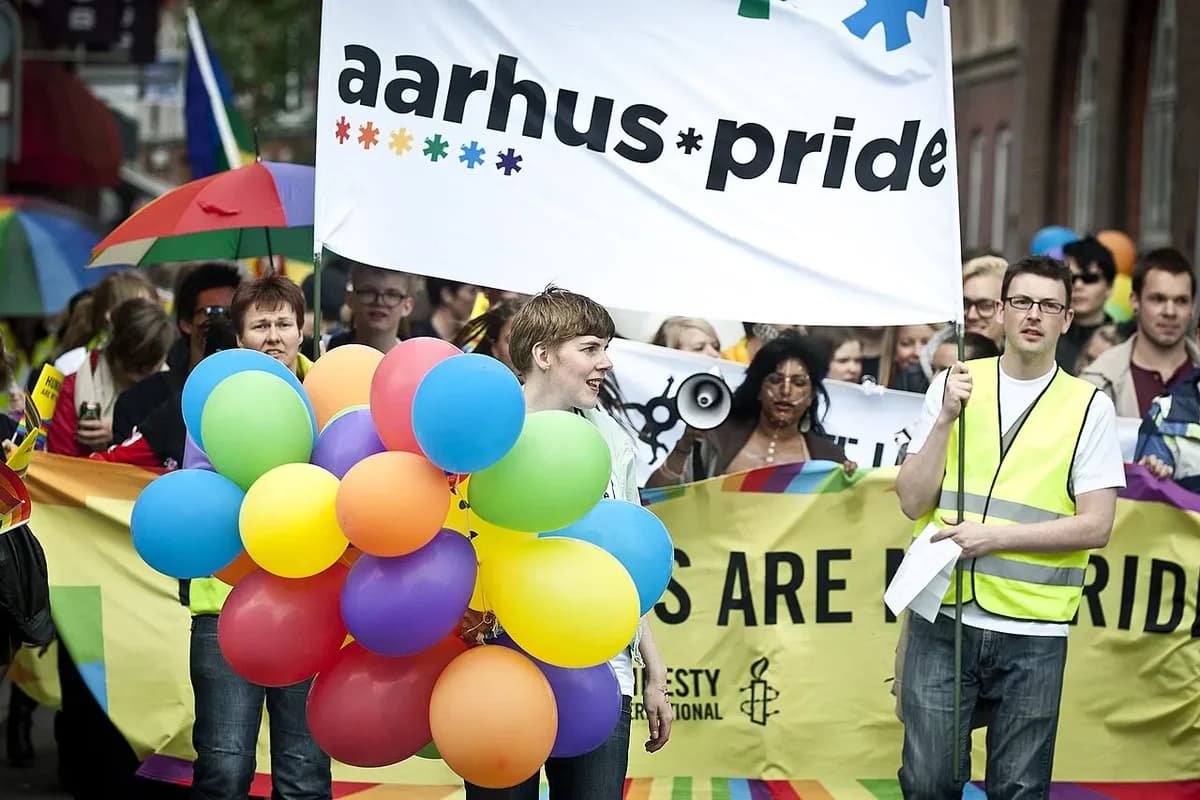 People marching with balloons and banners at Aarhus Pride 2012 parade