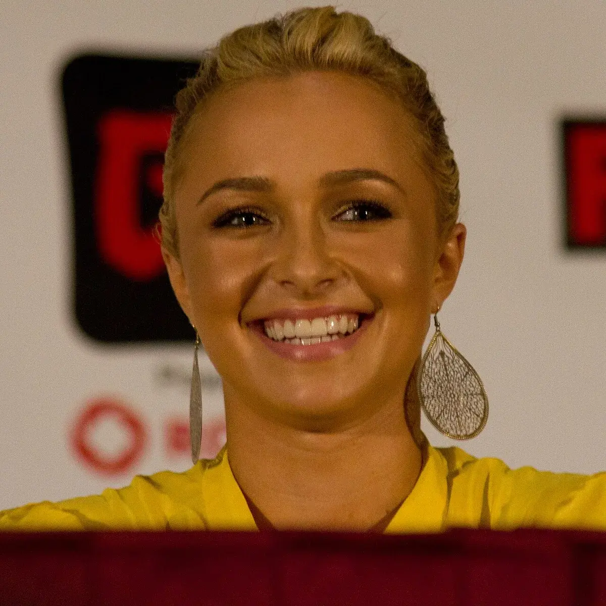 Smiling woman with blonde hair and yellow top