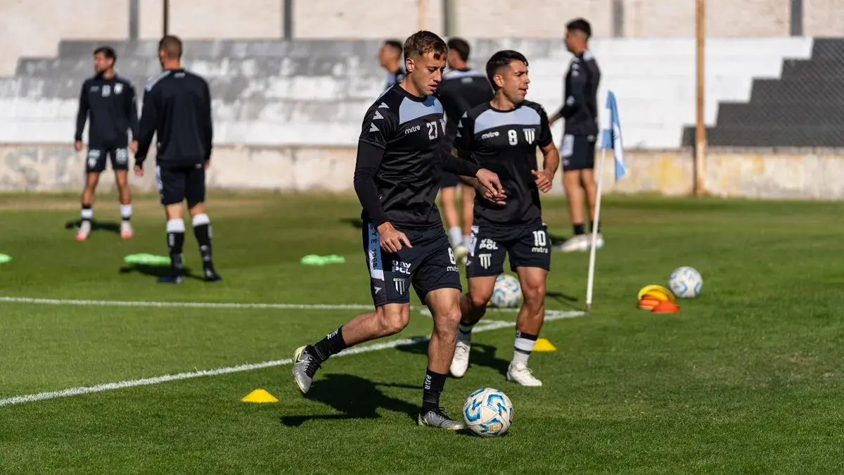 Young football players practicing on a sunny football field