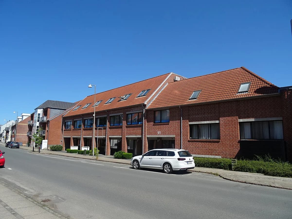 Brick office building on a street in Aarup, Denmark.