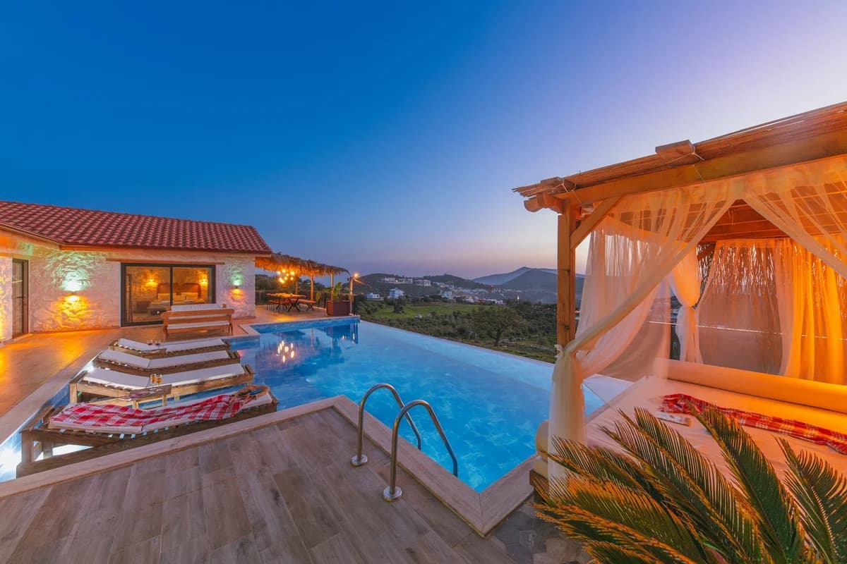 Luxury villa with infinity pool and cabana overlooking Kas at sunset