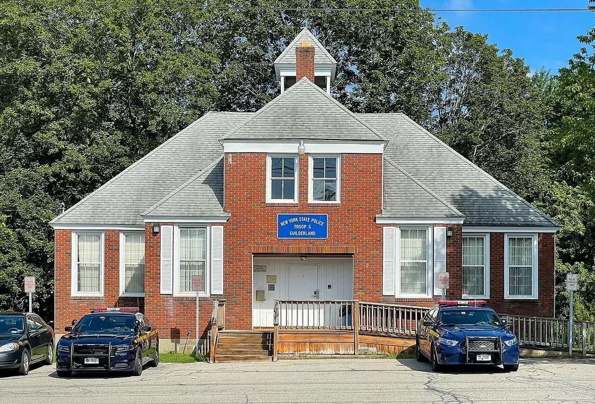 New York State Police station in Guilderland with two patrol cars parked outside.