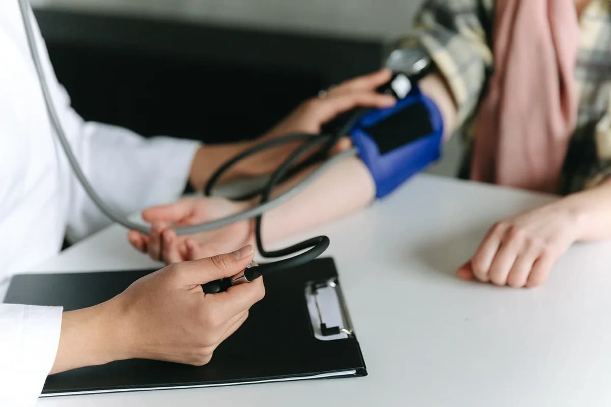 Close-up of a clinician taking a patient's blood pressure.