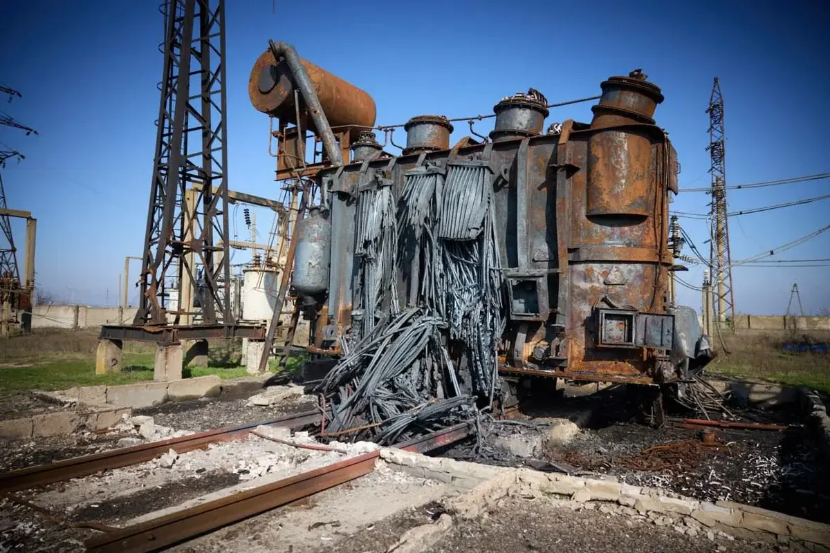 A burned and damaged electrical transformer at an energy facility.