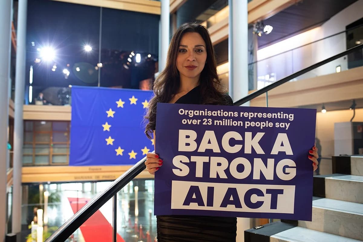 Woman holding a sign advocating for a strong AI Act