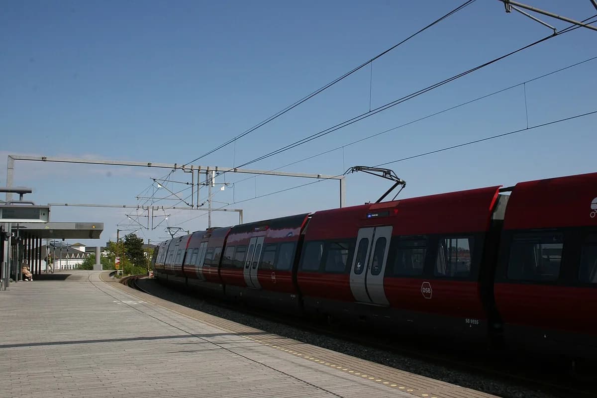 A red S-train at a station platform in Copenhagen.
