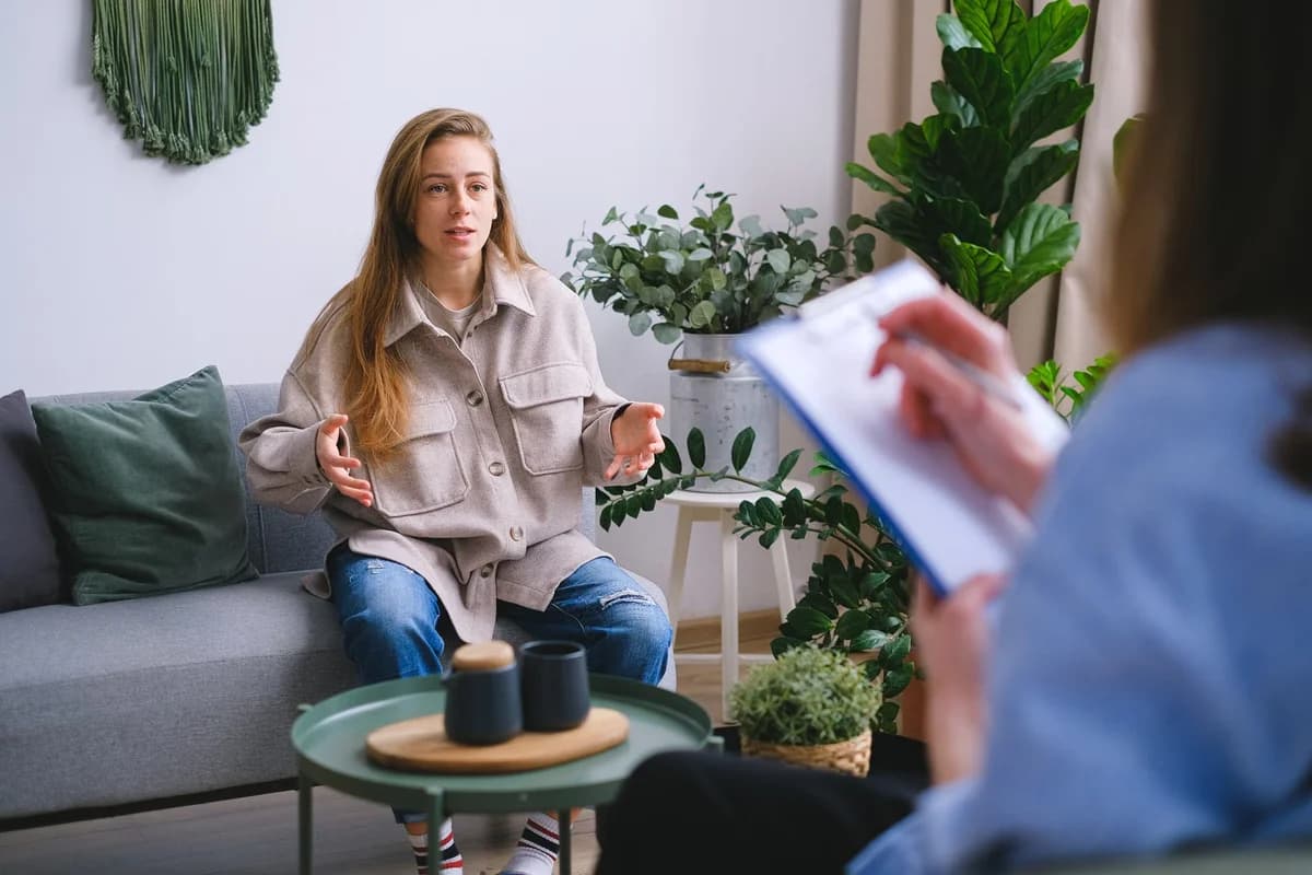 Worried woman talking in psychotherapy session