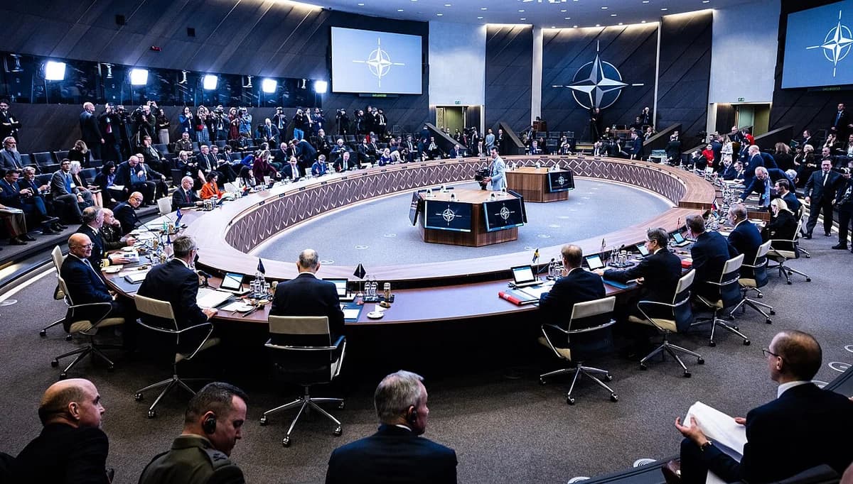 Wide view of a NATO foreign ministers' meeting in a conference hall in Brussels.