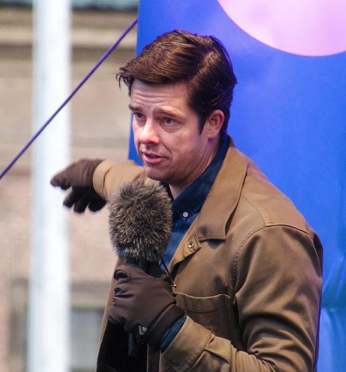 A man speaking into a microphone at a demonstration.