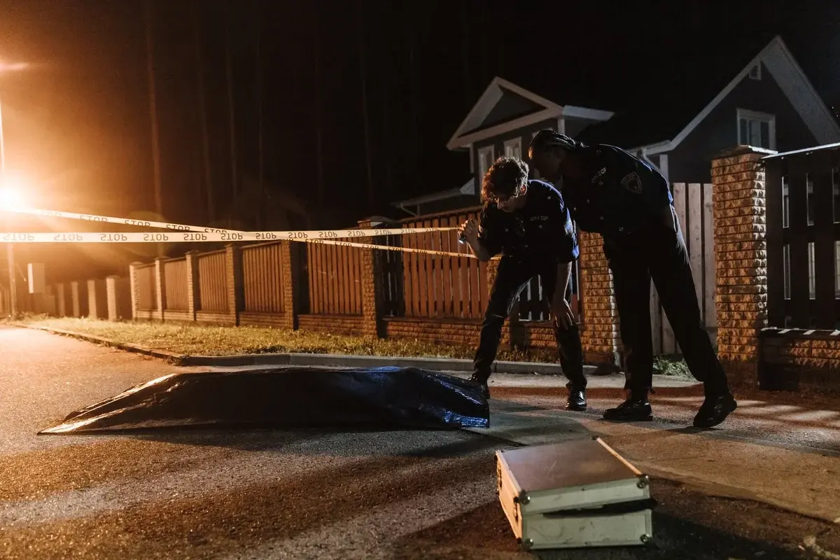 Police officers investigating a crime scene at night