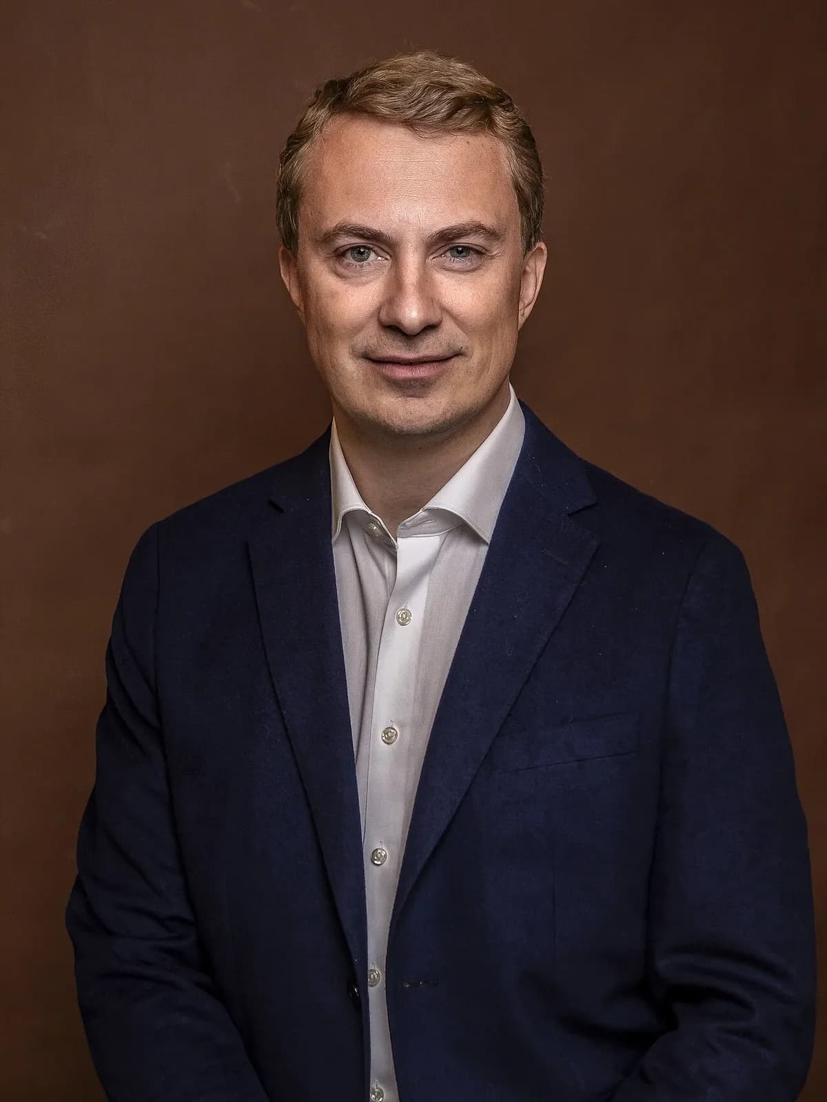 Man in navy blazer and white shirt portrait