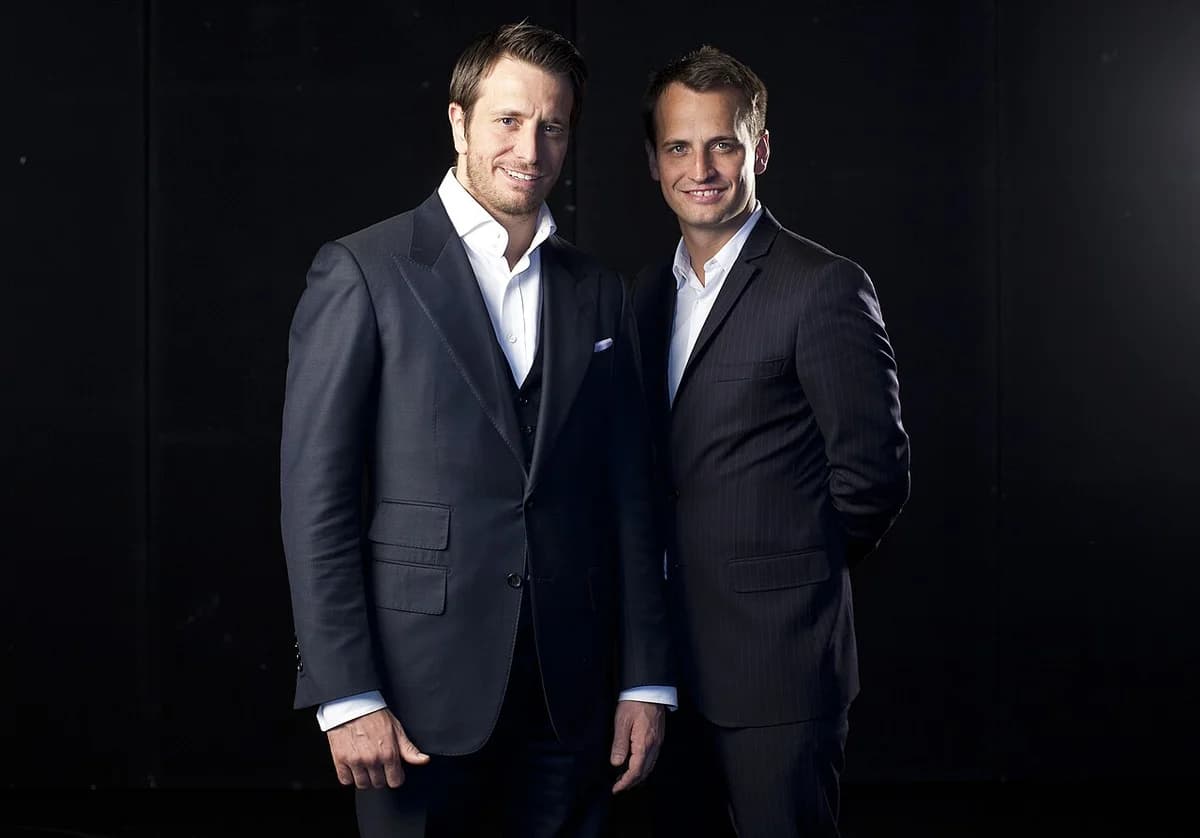 Two men in suits posing together for a portrait.